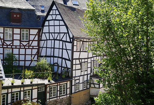 Monschau, Germany (Eifel) - July 9. 2020: View on river with timber frame monument houses in center of medieval village