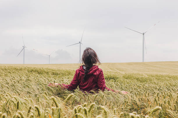 istock Woman is walking in wheat field 1258143834