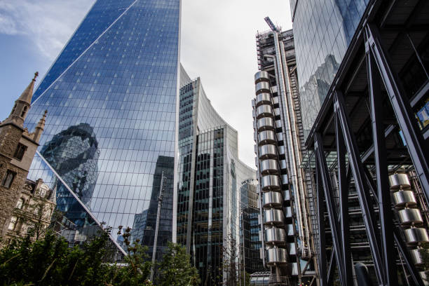 istock Corporate buildings, old church and tree's 1258144018