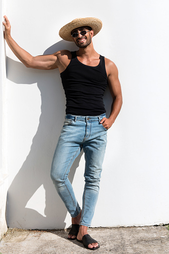 male model with straw hat posing in the sun
