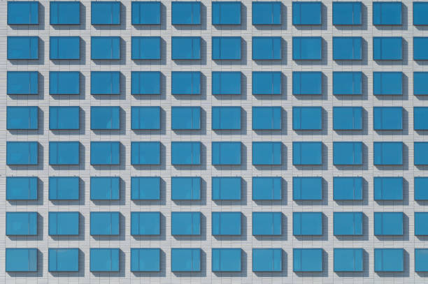 istock An abstract view of blue square glass windows on white surface. 1258146252