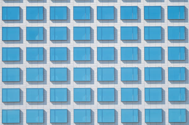 istock An abstract view of blue square glass windows on white surface. 1258146255