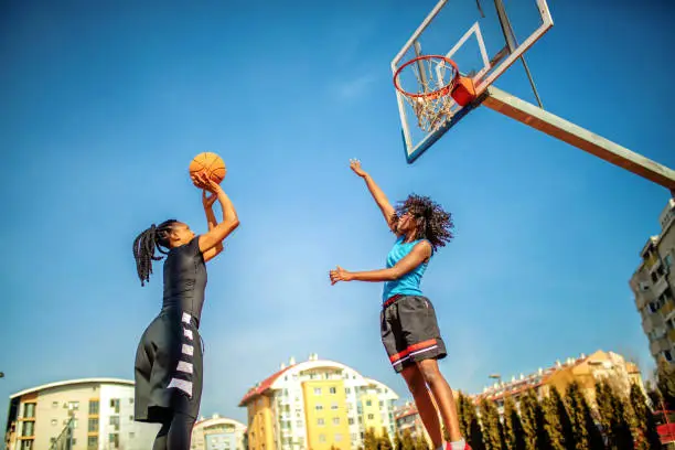 Street female basketball players playing basketball on the court