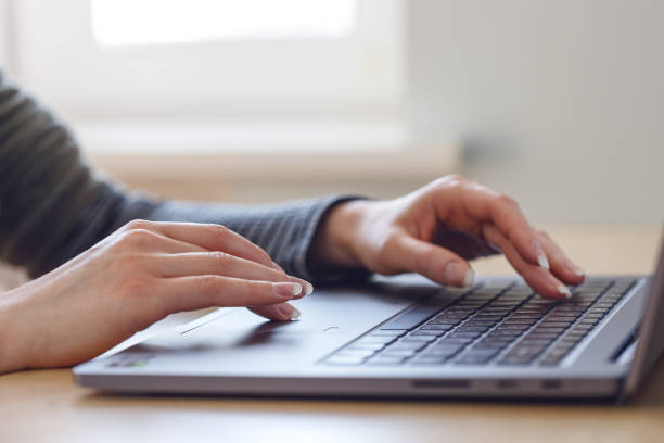 istock Woman using laptop indoor. 1258148579