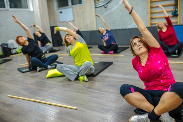 istock Large group of diverse age women exercising with an instructor 1258149547
