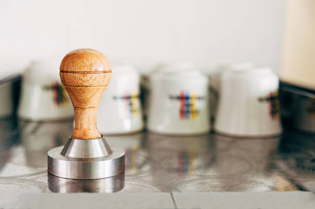 istock Coffee press on coffee machine with bottom of coffee cups 1258150480