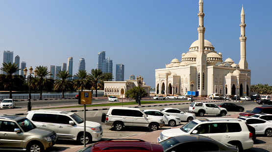 Country-U.A.E, City- Dubai, Date 22/07/2020 Car's park in open parking lot in Dubai with background of building and mosque