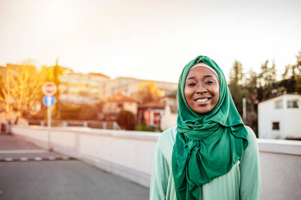 Portrait Of Muslim Woman In Urban Environment. Portrait Of Muslim Woman In Urban Environment. Smiling Muslim Woman Wearing Hijab. Portrait of smiling muslim woman outdoors. Muslim businesswoman chubby arab stock pictures, royalty-free photos & images