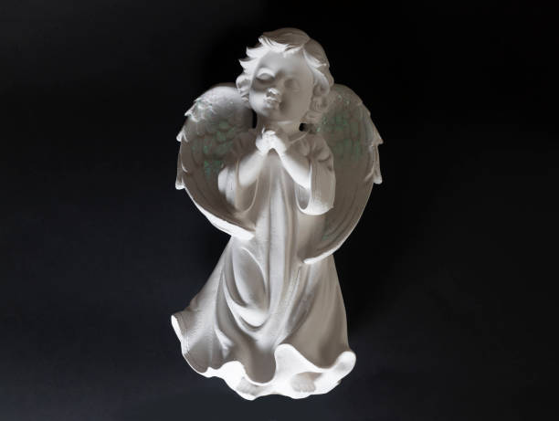 istock figurine sculpture of angel on a black background with backlight 1258155575