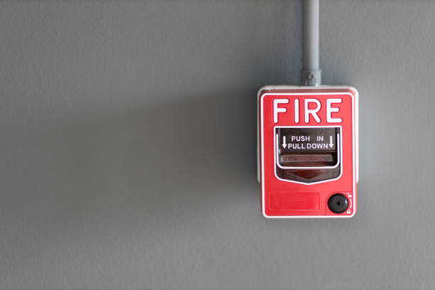 istock fire alarm box on cement wall for warning and security system in the condominium place. standard safety in the resident, shopping mall and public place concept. image for copy space, background. 1258156198