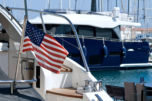 American national flag on boat in sea harbor