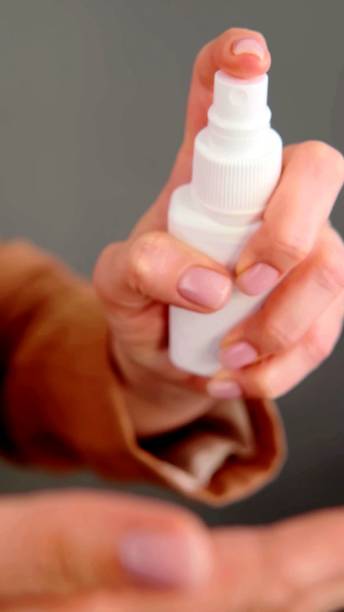 istock the hands of a woman who is using a spray 1258156425