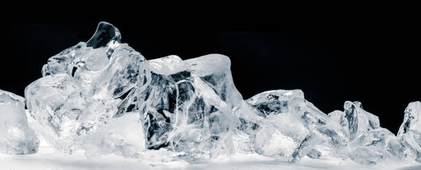 istock Pieces of crushed pure ice cubes on black background. 1258159741