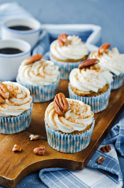 istock Carrot cinnamon cupcakes with cream cheese and pecan nuts 1258163868