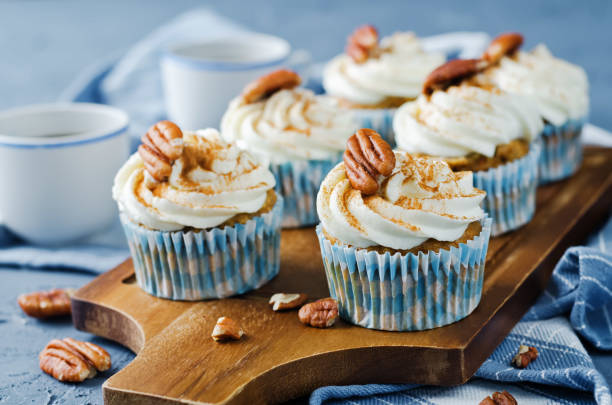istock Carrot cinnamon cupcakes with cream cheese and pecan nuts 1258163875