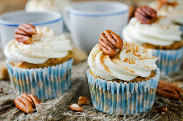 istock Carrot cinnamon cupcakes with cream cheese and pecan nuts 1258163877