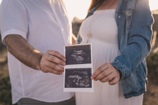 istock A pregnant woman looking at her echography. 1258164836