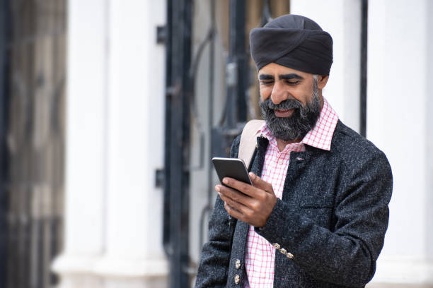 istock Silk businessman with turban using smart phone 1258165818
