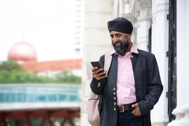 istock Silk businessman with turban using smart phone 1258165898