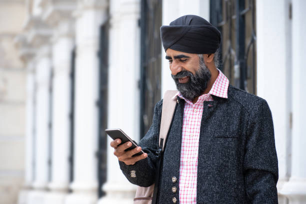 istock Silk businessman with turban using smart phone 1258165902