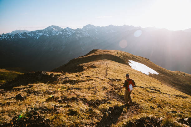 istock Backpacker Hiking Mountain Ridge With View of Olympics 1258166705