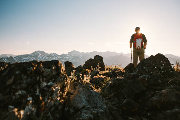 Backpacker Hiking Mountain Ridge With View of Olympics