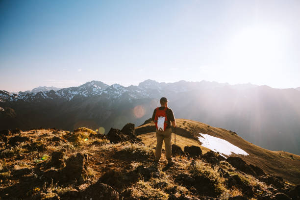 Backpacker Hiking Mountain Ridge With View of Olympics