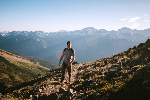 istock Backpacker Hiking Mountain Ridge With View of Olympics 1258167985