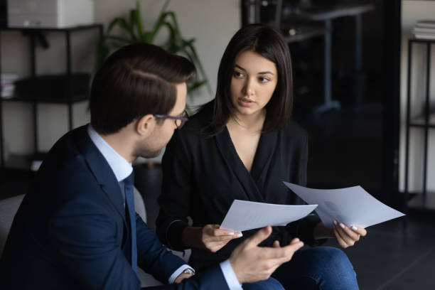 istock Multiracial businesspeople cooperate discuss paperwork in office 1258168087