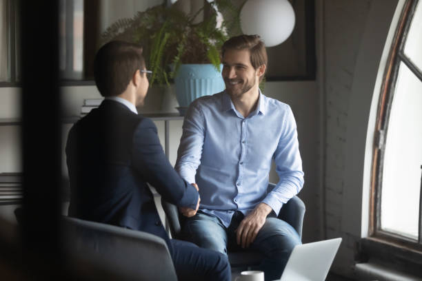 istock Smiling businessmen handshake get acquainted at briefing 1258168115