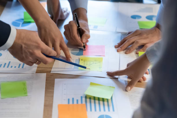 istock Top close view of employees analyze financial paperwork 1258168157