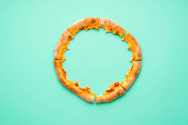 pizza crust only isolated on a green background. pizza leftovers top view. - pastrie imagens e fotografias de stock