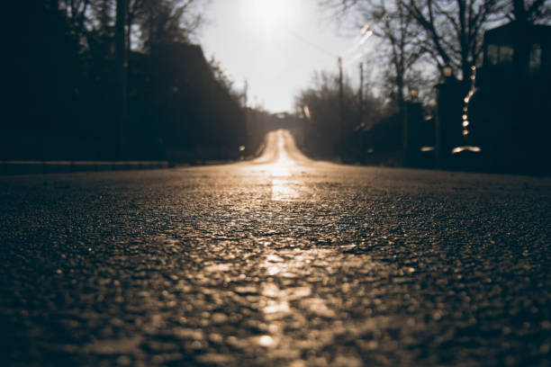 istock Long road perspective with textured asphalt 1258170878