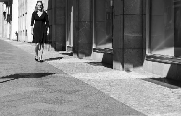 istock Man Walking On Footpath In City 1258171309