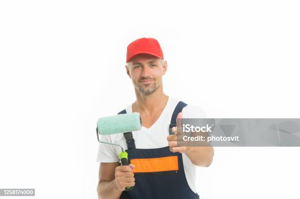 Wall Painting Is Eco And Economic Paint Rolling Decorator Hold Paint Roller Wall Painter Paint Work Renovation And Repair Renewal And Redecorating Professional Equipment Mature Man In Cap Stock Photo - Download Image Now