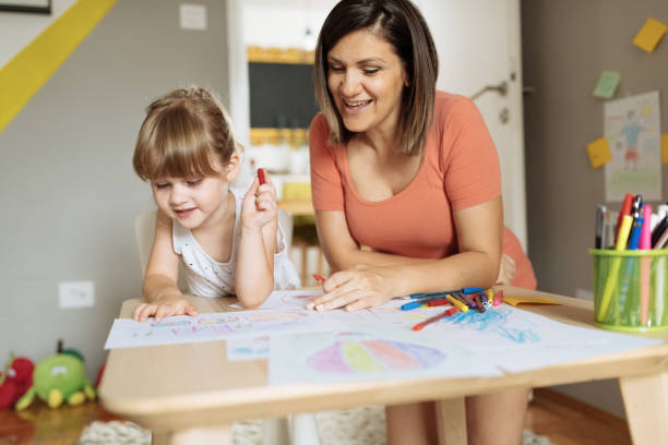 istock Mother and three year old girl playing - drawing at home during lockdown 1258179861