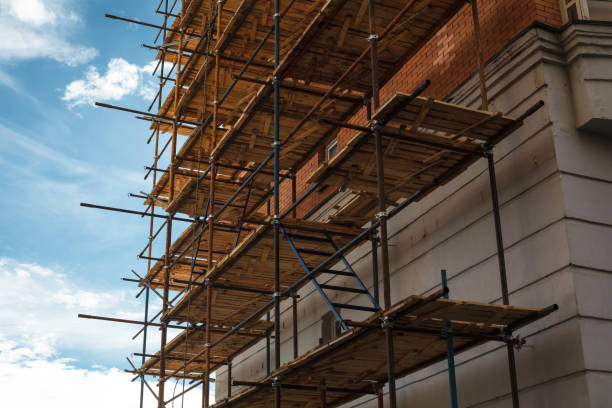 istock Building under construction with scaffolds, house renovation. Scaffolding on the construction site 1258183643