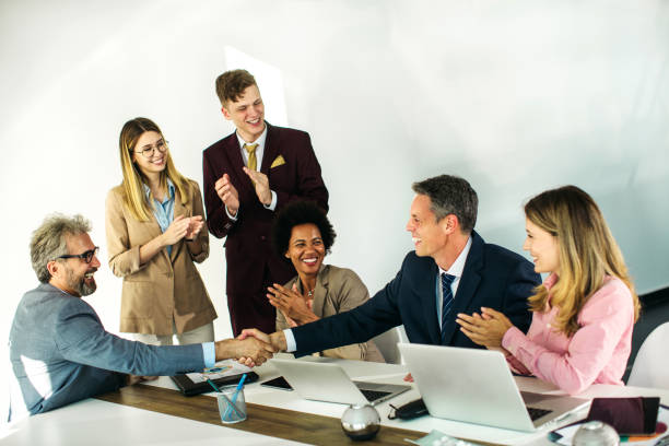 istock Group of businesspeople handshake 1258184448