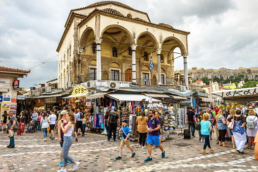 Athens - May 7, 2018: Tzistarakis mosque and old market on Monastiraki square in Athens, Greece. People visit Athens city center in summer. Monastiraki is one of main tourist attractions in Athens.