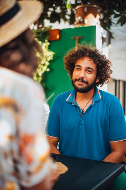 istock Man Enjoys Spending Time With His Friend at Cafe 1258195227