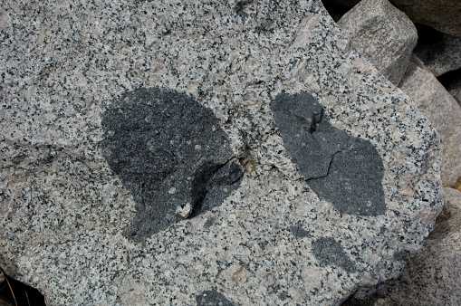 Xenoliths in Granite, near Wheeler Ridge, Pine Creek Canyon, East Sierra Nevada Mountains, California, Geology, Igneous rock. Gabbroic xenolith in granite.