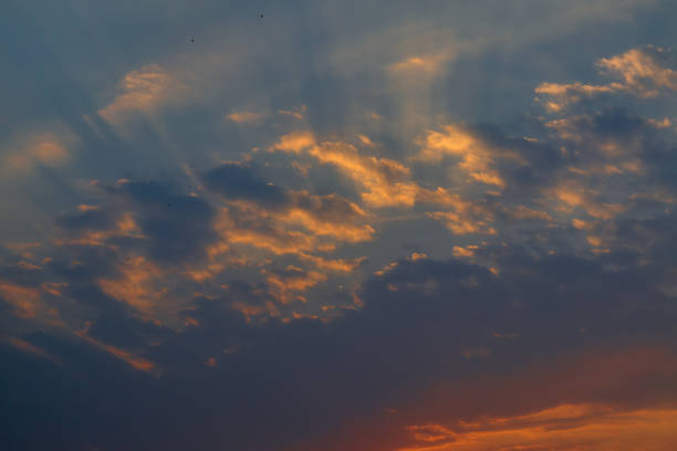 istock The sky at sunset. Cumulus clouds lit by the rays of the setting sun. 1258202010