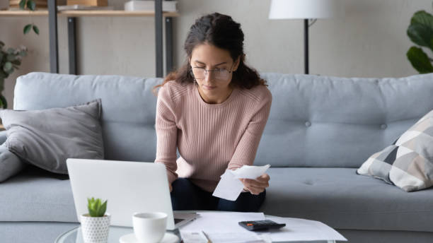 istock Serious female manage family finances using laptop 1258280068