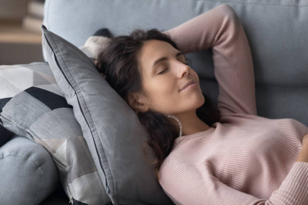 istock Calm millennial girl relax on couch daydreaming 1258280094