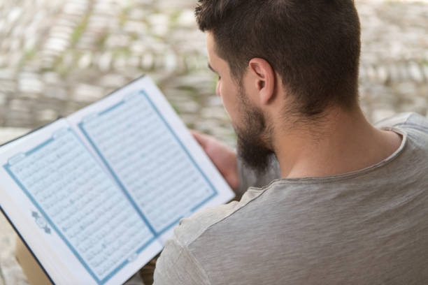 istock Arabic Muslim Man Reading Holy Islamic Book Koran 1258280682