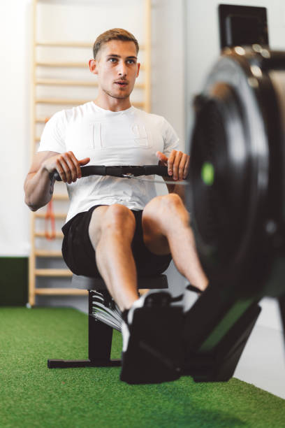 istock Muscular man rowing hard at the gym 1258283055