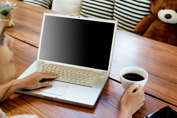 Close-up asian women are using laptops to work at home, online working, video call due to social distancing