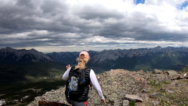 istock Female hiker traverses mountain ridge 1258290323