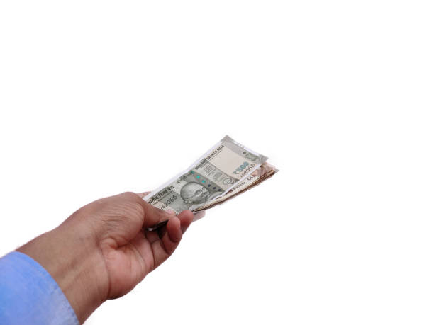 istock Indian Banknote in hand offering money Concept on White background 1258304268