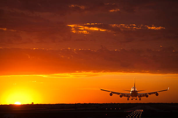 istock A jet airplane comes in for a landing at sunset 125833448